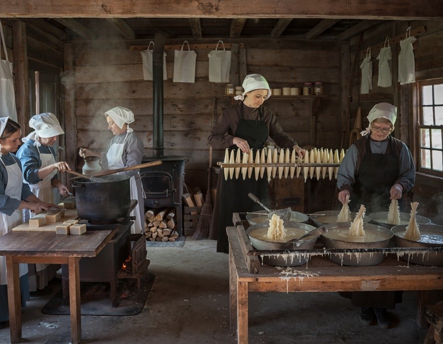 Women making soap and beeswax candles in the settlement shop